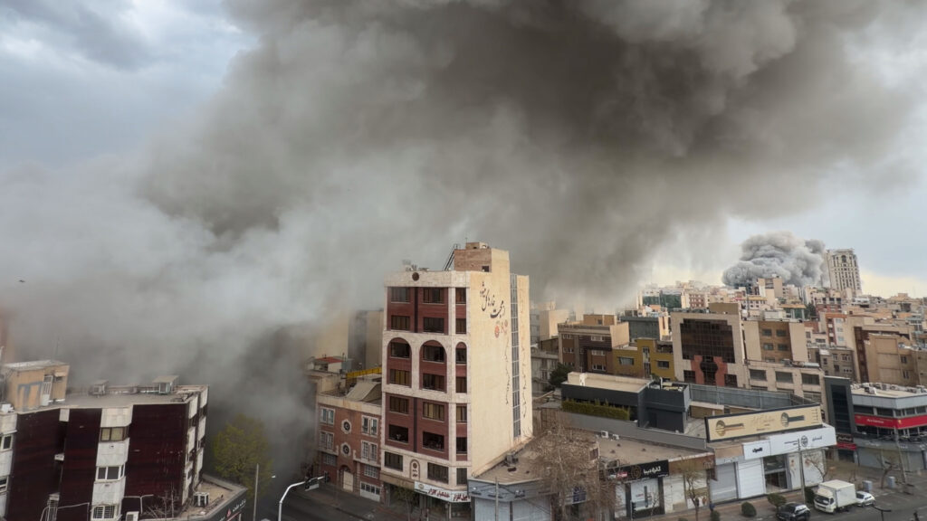 IRAN ATTACKS - Plumes of smoke from two simultaneous strikes rise over Tehran, Iran, Monday, March 2, 2026. AP Photo/Mohsen Ganji