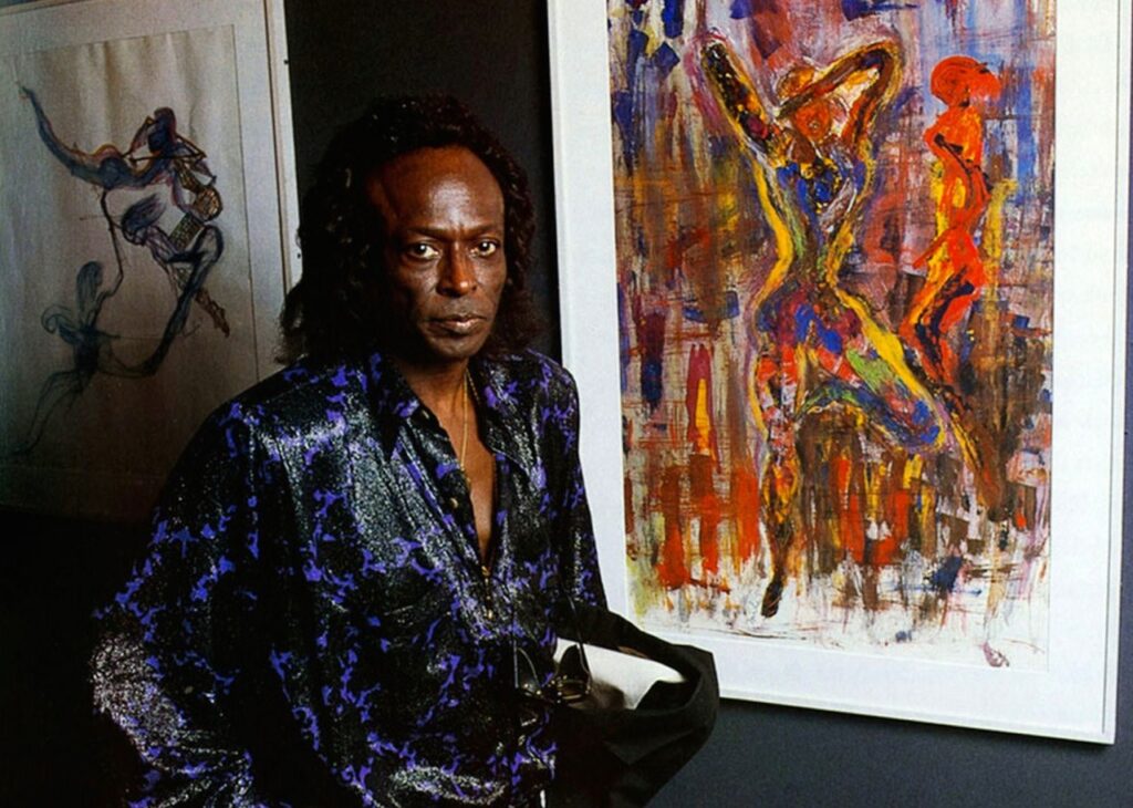 Miles Davis standing before a Jean-Michel Basquiat–inspired artwork of his own in the late 1980s. [Image: Art, Artists, Artwork via Facebook]
