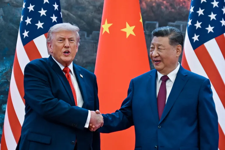 US President Donald Trump shakes hands with China's President Xi Jinping at the Great Hall of the People in Beijing. [Kenny Holston/Pool via AFP]
