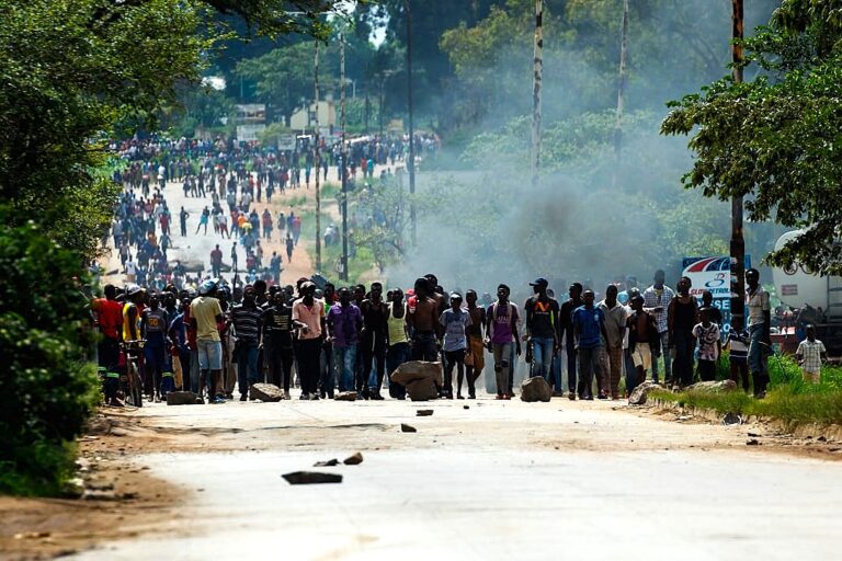NATIONAL SHUTDOWN ZIMBABWE - IMAGE: INTERNATIONAL CRISIS GROUP - Angry protesters barricade the main route to Zimbabwe's capital Harare from Epworth township on January 14 2019 after announced a more than hundred percent hike in fuel prices. - Angry protesters barricaded roads with burning tyres and rocks in Zimbabwe on January 14 after the government more than doubled the price of fuel in a bid to improve supplies as the country battles its worst gasoline shortages in a decade. (Photo by Jekesai NJIKIZANA / AFP)