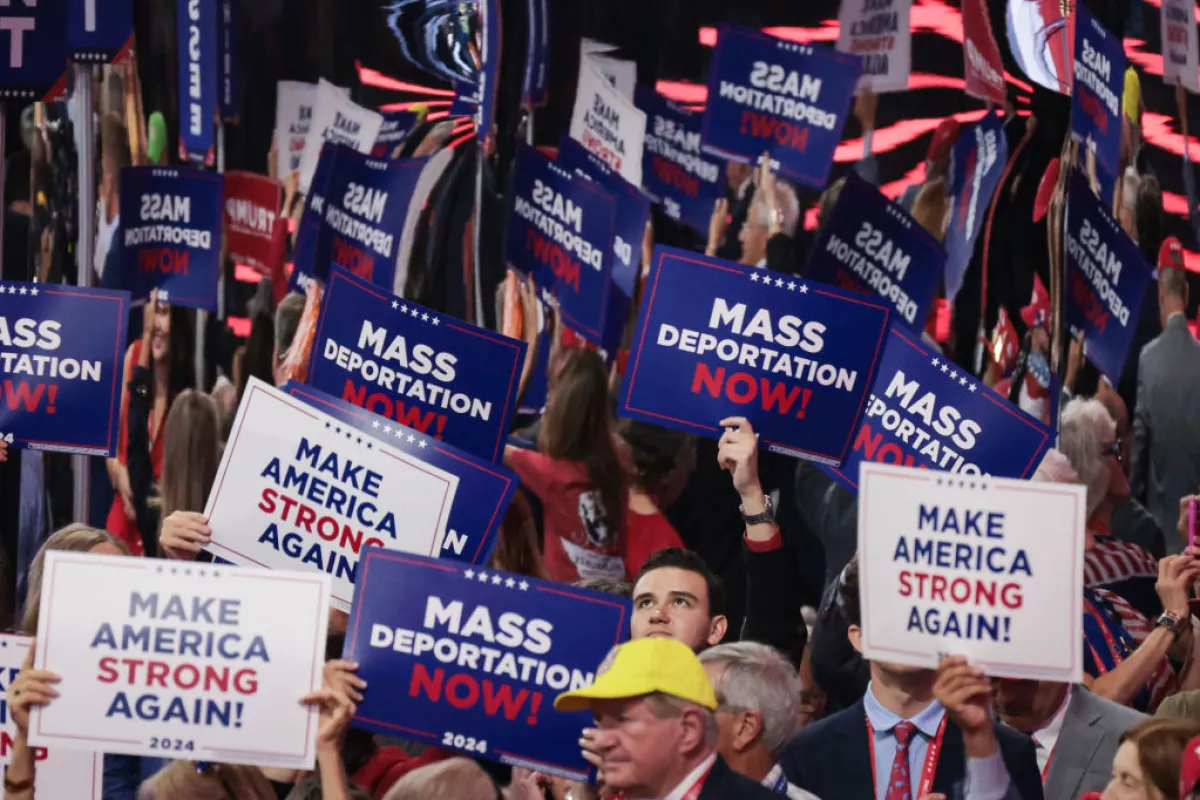 AS MANY AS 3 MILLION IMMIGRANTS DEPORTED UNDER TRUMP'S SECOND TERM - Attendees at the Republican National Convention hold up signs reading "Mass Deportation Now!" last month in Milwaukee. IMAGE: Scott Olson/Getty Images