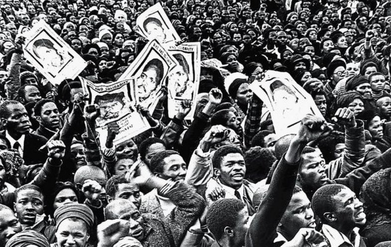 BLACK CONSCIOUSNESS AND THE UNFINISHED PROJECT OF LIBERATION - Demonstrators hold up images of Steve Biko at his funeral in September 1977 after he had been murdered in police custody. IMAGE: SA HISTORY