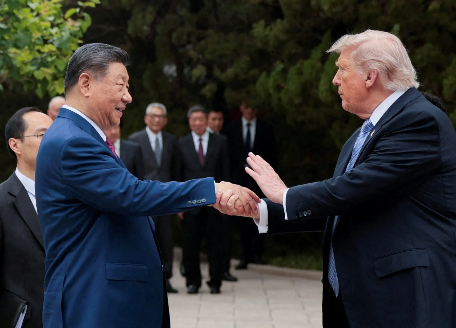 DONALD TRUMP AND XI JINPING SHAKING HANDS - IMAGE: REUTERS VIA AL JAZEERA